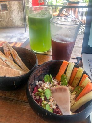 Beet hummus, infused water and a coffee from nearby coffee shop.  at Peace & Bowl in Playa Del Carmen