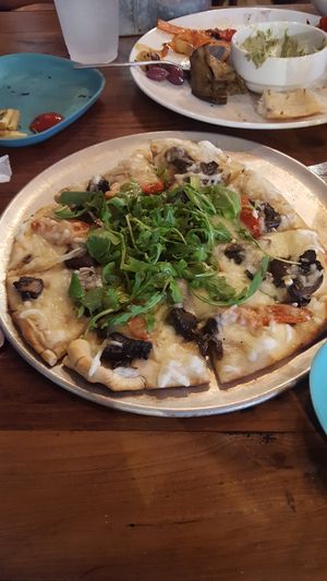 The arugula mushroom tomato pizza with remains of the grilled veggie charcuterie at Moondog in Key West