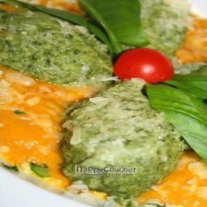 Home made spinach gnocchi and Sardinian ricotta served on top of a carrot squash creme sauce with orange Mediterranean herbs. 
 at Lei e Lui in Berlin