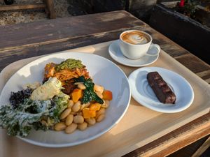 Lasagna and salad with a coffee and bounty bar at The Happy Pear in Greystones