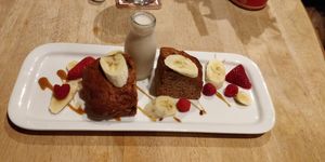 Dark rum and banana cake served with a little bottle of almond milk at South Causey Inn in Stanley