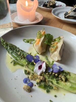 Asparagus, hollandaise, pistachio. Winter kimchi gyozas, fermented chilies.   at Magu in Helsinki