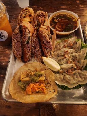(Burrito in front not vegan), Tofu ramenritto, veggies dumplings, Tofu taco, angry veggies broth at Cris and John in Dallas