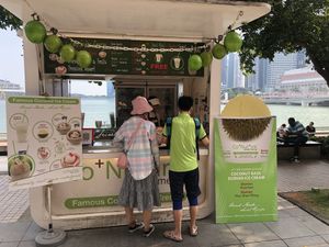 the stall, Merlion in background 👍 at Co+Nut+Ink - Esplanade in Central Singapore