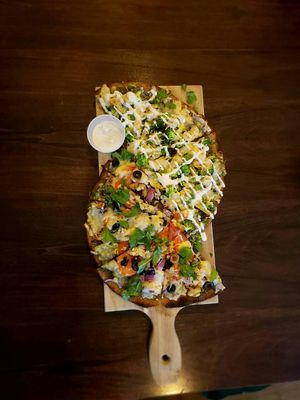 ½ Freaky Greeky (bottom) and ½ Pesto Prana (top) at Vegan Cave Tanoor Pizza in Vancouver