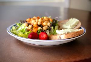 Big Island Creamery mac nut cream cheese on bread with a side salad. at Kamuela Farmers Market in Waimea