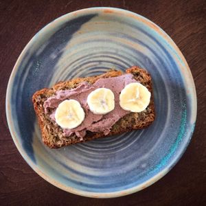 Big Island Creamery mac nut cream cheese (Macnutella: cacao nibs, sweetened with cane juice) on banana bread.  at Kamuela Farmers Market in Waimea
