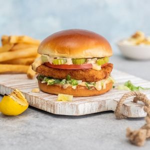 Cajun Fish Sandwich: Crispy Good Cath ™ fish filet, lettuce, tomato, pickled celery, and Cajun devil sauce on a toasted brioche bun | sub Baja Tarter Sauce at Veggie Grill by Next Level - UCLA Ackerman Union in West Los Angeles