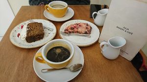 Courgette cake, raspberry scone and coffees. at Julia Bakery in Malaga