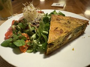 Spelt quiche with spinach, feta cheese, sun-dried tomatoes and sunflower seeds and salad  at Cafe Madrigal in Valencia