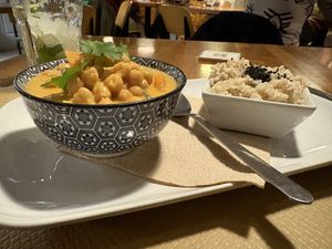 Thai red chickpea curry with pumpkin, spinach, coconut milk and brown basmati rice  at Cafe Madrigal in Valencia
