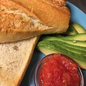 Breakfast with avocado, tomato and toasted bread at Cafe Madrigal in Valencia