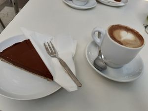 Chocolate cake and coffee with almond milk at Cafe Madrigal in Valencia