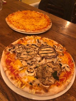 Pizza margaritha and pizza with mushrooms, eggplant and union at Trattoria Toto in Amsterdam
