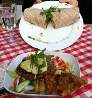 Top: The vegan wrap with hummus
Bottom: The vegan salad, with lettuce, cucumbers, olive oil, tomatoes, red bell pepper, cashews, and onions; topped with a homemade lentil patty and hummus, and incredibly delicious vegan crostini with olive oil at Pygmalion in Bergen
