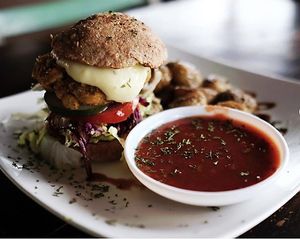 This is house made Gourmet Vegan Burger made with wholemeal buns! at Cafe Compassion at Hostel La Tortuga  in Ayampe