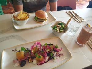 The burger and the beetroot and 'goat's cheese' salad (I asked for it main size) with a side of garlic, lemon and almond broccoli and a tropical smoothie! at Twelve Eatery in Bournemouth