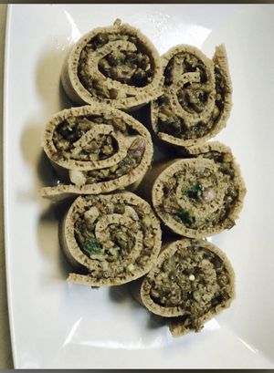 Whole brown lentils rolled with Enjera! Served cold  at Enat in Charlotte