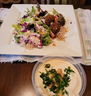 Vegan rice bowl with garlic sauce and falafels, plus side of hummus.  at Hummus Mediterranean Grill in Hagerstown