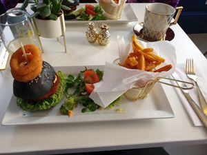 Cheese burger with onion rings, salad and chips at Naked Bakery in Edinburgh