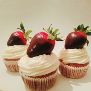 Chocolate dipped strawberries on a vanilla cupcake with vegan cream cheese icing at Sweets by Pepper in Geneva