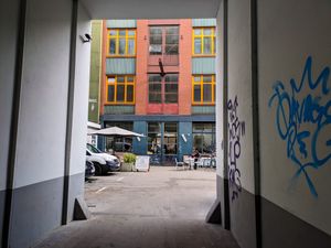 View of the outside of The Visit Coffee Roastery from the driveway into the courtyard at The Visit Coffee Roastery in Berlin