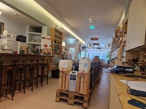 Inside shop- seating at the rear and bar at Little Plant Pantry in Amsterdam
