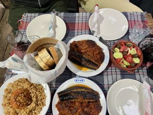 Stuffed pepper, stuffed aubergines, salad, bread and wine   at Lili Homemade Food in Berat