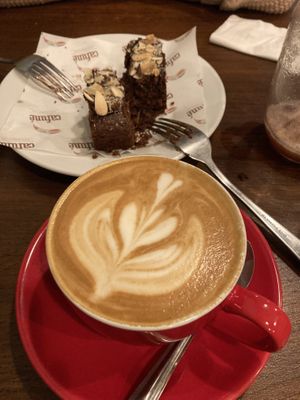 Flat white and chocolate almond cake at Cafuné in Preston