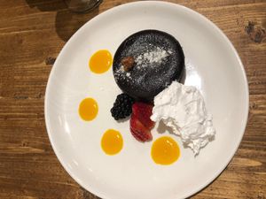 Chocolate fondant with berries, pineapple gel and cream at Gallo Santo in Barcelona