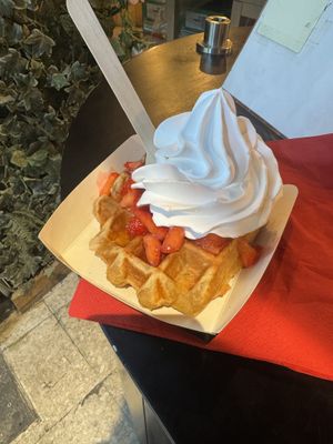 Waffle with whipped cream, maple syrup, and strawberries  at VeganWaf in Brussels