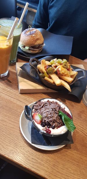 Cherry vanilla porridge with extra chocolate (amazing), sloppy joe burger and chili cheese fries! at Spreegold in Berlin
