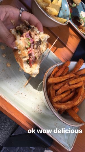 Half eaten vegan burger with sweet potato fries  at Hans im Glück in Frankfurt