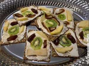 Mulitgrain crackers spread with delicious homemade vegan cream cheese topped with dates, apples, and pear drizzled with agave. Yum! at My Conscious Plate in Lake Worth