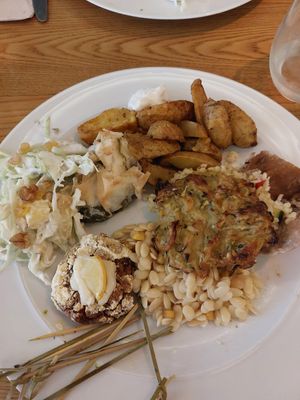 Fried potatoes, spinach and courgette fritata, lentil burgers, salad. at DaTerra - Rua da Rosa in Lisbon