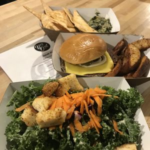 Some of the favorites! Kale Caesar, impossible burger, and spinach and artichoke dip served with house made tortilla chips.  at VegOut in Bethlehem