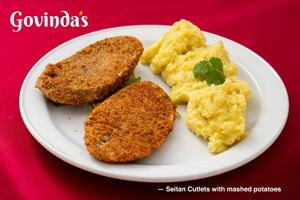 Seitan Cutlets with mashed potatoes. Vegetarian hamburger with Potato Garnish and two kind of sauces. Menu of the Day price €9,80 at Govindas in Tenerife