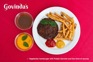 Vegetarian hamburger with Potato Garnish with sauces. Vegetarian hamburger with Potato Garnish and two kind of sauces. Menu of the Day price €9,80 at Govindas in Tenerife