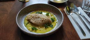 Crêpes filled with artichoke and Jerusalem artichoke in saffron and rosemarysauce and macadamia-parmesan. at The Meets Restaurant in Amsterdam