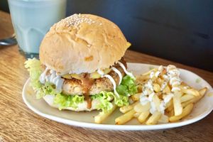 Handmade tempeh mushroom patty served on wholemeal bun with caramelized pineapple, special sauce, eggless mayo and air-fried fries at Pando Cafe in Kota Kinabalu