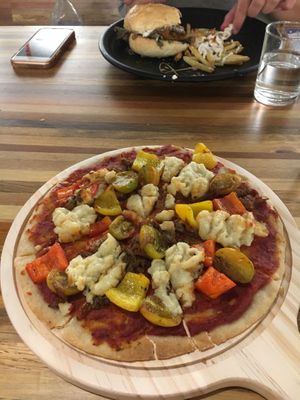 BBQ chicken pizza and black pepper burger in the background  at Pando Cafe in Kota Kinabalu