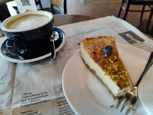 Matcha oat, vegan cheesecake and sunday newspaper at Grand Café Lochergut in Zurich