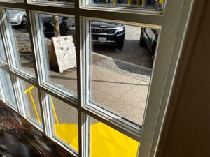 A frame sign out front with outdoor seating  at Root in Newport