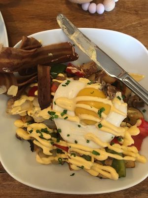 Vegan breakfast bowl: sunny side up (v)egg with bacon, hash browns and veg, topped with hollandaise sauce. at Nateure's Plate in Peterborough