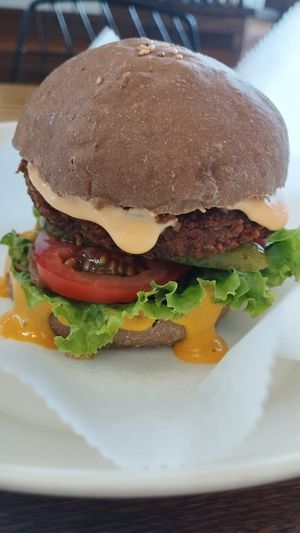 Their classic vegan burger with dripping "cheese", so yum! at Nourish in Hoi An