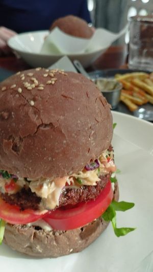 Falafel burger with an extra side of sweet potato fries. at Nourish in Hoi An