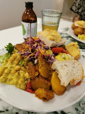 Buffet plate with chickpea curry, riasted veggies, smoked tofu, baked potatoes and more at Donna Veggie in Guimaraes