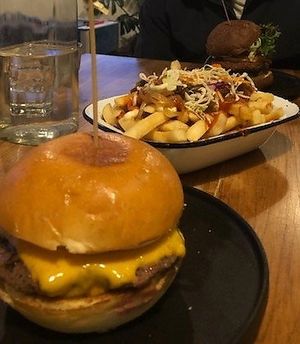 Beef cheese burger, loaded fries (vegan option) and in the background is the spicy lentil burger at Burger Baby in Margaret River