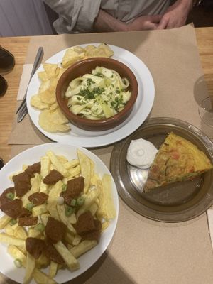 Noquerones (vegan anchovy - salty goodness), chorizo and fries, and great tortilla! Order it all!   at La Piparra in Bilbao