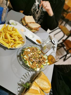 fries with 4 different sauces, tofu salad, vegan blt and a sandwich with cashew cheese and vegan chorizo at La Piparra in Bilbao